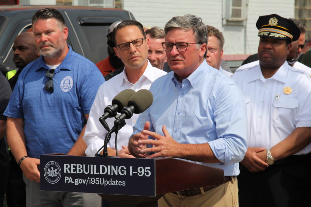 Mike Carroll speaking at a podium.