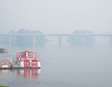 A boat on the river with very hazy sky