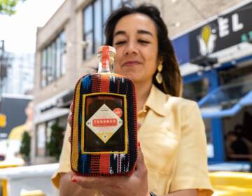 Sofia Deleon poses with a bottle of her new Guatemalan rum.