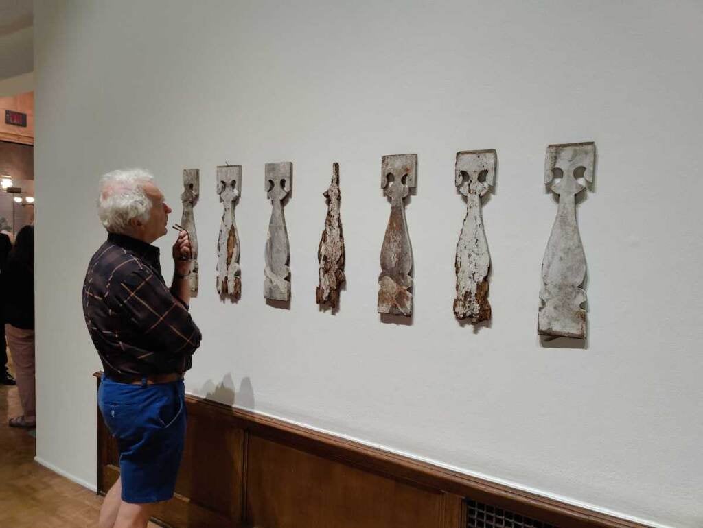 A visitor to the gallery looks at Adebunmi Gbadebo’s artwork, displayed on the wall.