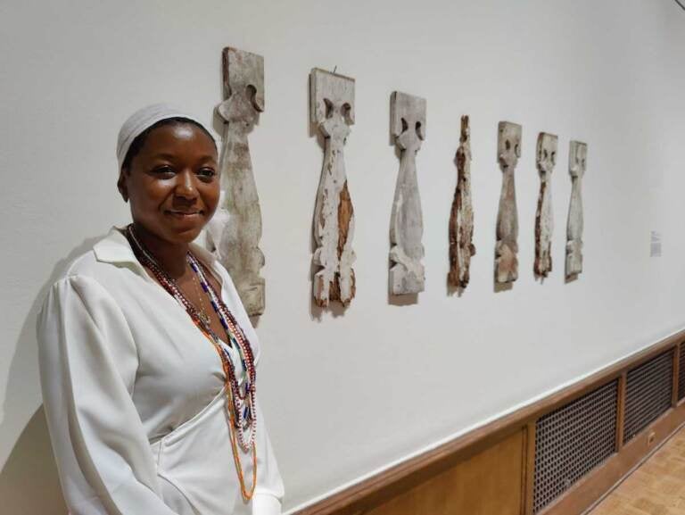 Artist Adebunmi Gbadebo stands with her piece “Remains, piece of Balcony Baluster, 1848,