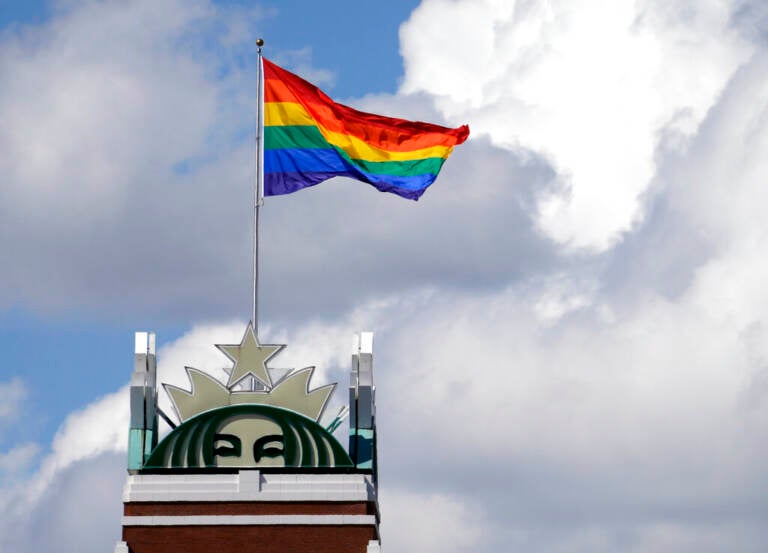 A Pride Flag flies on top of the Starbucks logo on top of the company's headquarters in Seattle.