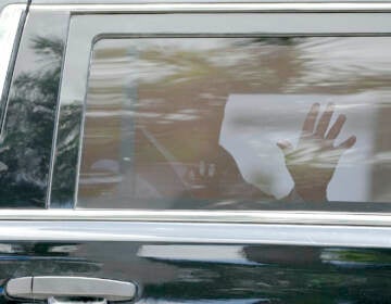 Trump waves from the car