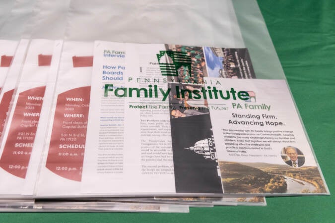 A stack of papers are visible in a bag printed with the name of the Pennsylvania Family Institute