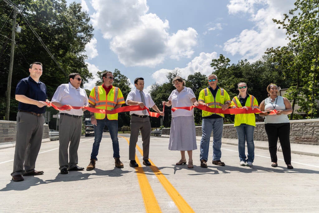 County officials cut a ribbon as they stand on the Mt. Alvern Bridge.