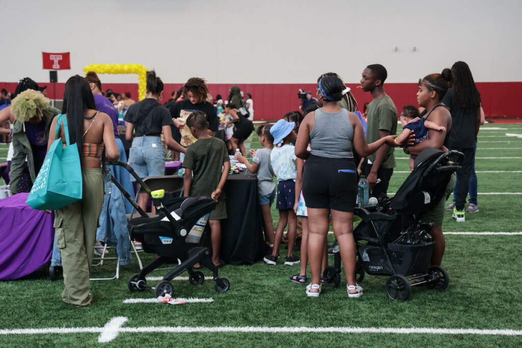 People gather around a craft table.