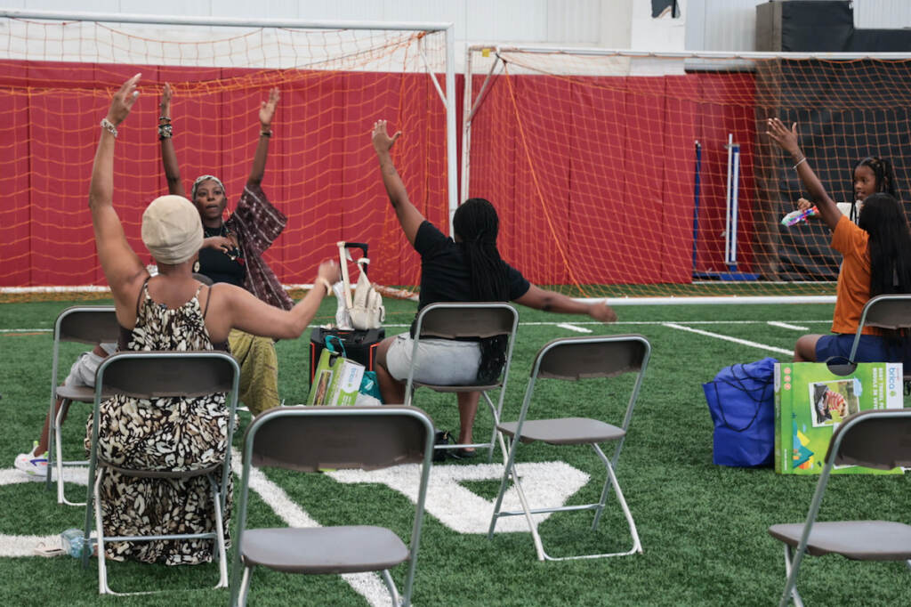 Instructor Jamilah Myann with Yoga 4 Philly leads prenatal yoga at the community baby shower