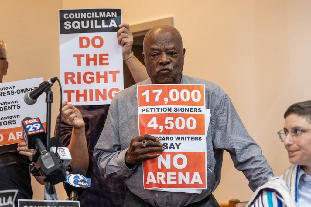 Dr. Walter Palmer holds a sign that reads No Arena.