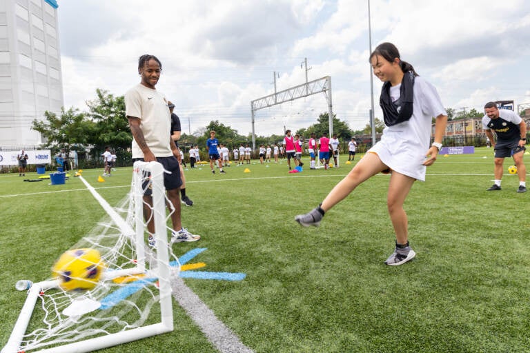 Chelsea professional football player Raheem Sterling helps Philadelphia kids learn how to play soccer at the Chelsea Foundation’s Football Festival at Cristo Rey High School on July 24, 2023