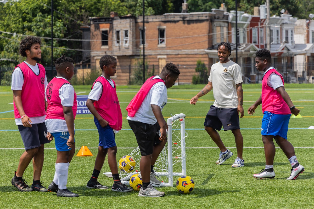 Chelsea professional football player Raheem Sterling helps Philadelphia kids learn how to play soccer at the Chelsea Foundation’s Football Festival at Cristo Rey High School on July 24, 2023