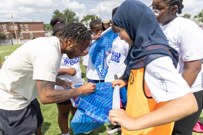 Professional Chelsea football player Levi Colwell give soccer tips to Philadelphia kids at the Chelsea Foundation’s Football Festival at Cristo Rey High School on July 24, 2023