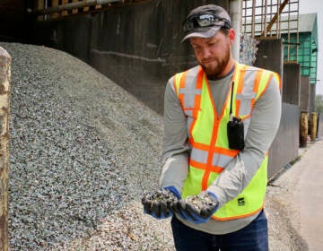 Plant manager Ryan Gregor holds handfuls of crushed glass