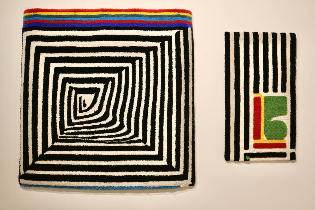 A view of a rug with a geometric design.
