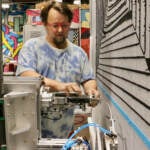 Tim Eads puts thread in a tufting machine.