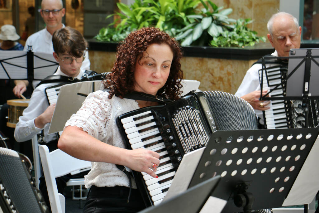 Christina Busso plays the accordion.