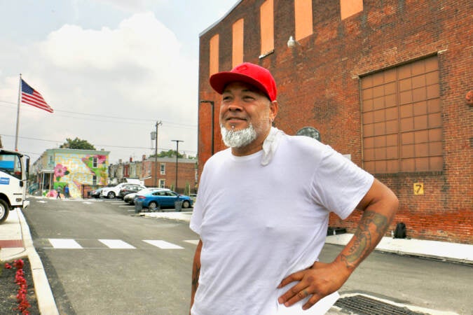 Guillermo Garcia, one of Impact Services' paid volunteers, has lived in the neighborhood for 30 years. He saiys he can see it coming back to life. (Emma Lee/WHYY)