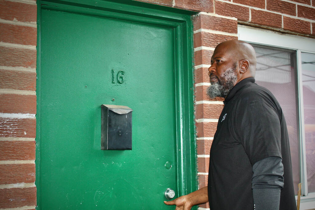 Camden County Health Inspector Sheron Floyd stands at a door.