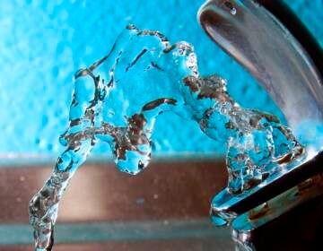 An up-close view of water flowing from a water fountain.