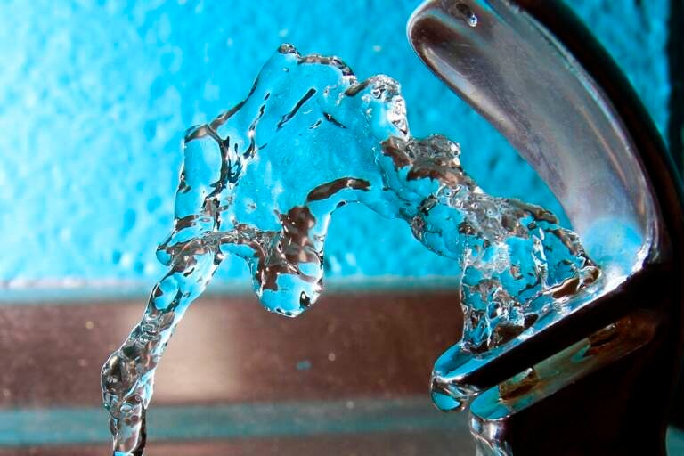 An up-close view of water flowing from a water fountain.