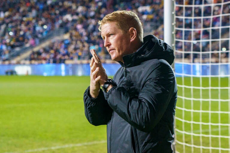 Philadelphia Union head coach Jim Curtin reacts to the crowd as he heads onto the field during the first half of an MLS playoff soccer match against the Nashville SC
