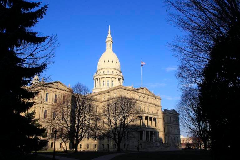 The Michigan Capitol building stands in Lansing, Mich., Dec. 12, 2012. Michigan's revenue will be nearly $900 million less this year than forecasted in January due to new tax cuts, state officials said Friday, May 19, 2023, leaving lawmakers with less money to spend as they work toward the state's next budget