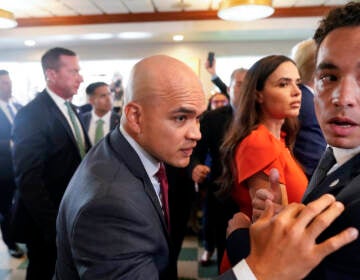 Former President Donald Trump's valet Walt Nauta, center, visits Versailles restaurant with Trump, June 13, 2023, in Miami. Nauta is set to be arraigned on charges that he helped the former president hide classified documents that the Justice Department wanted back. Nauta was charged earlier this month alongside Trump in a 38-count indictment filed by Justice Department special counsel Jack Smith.