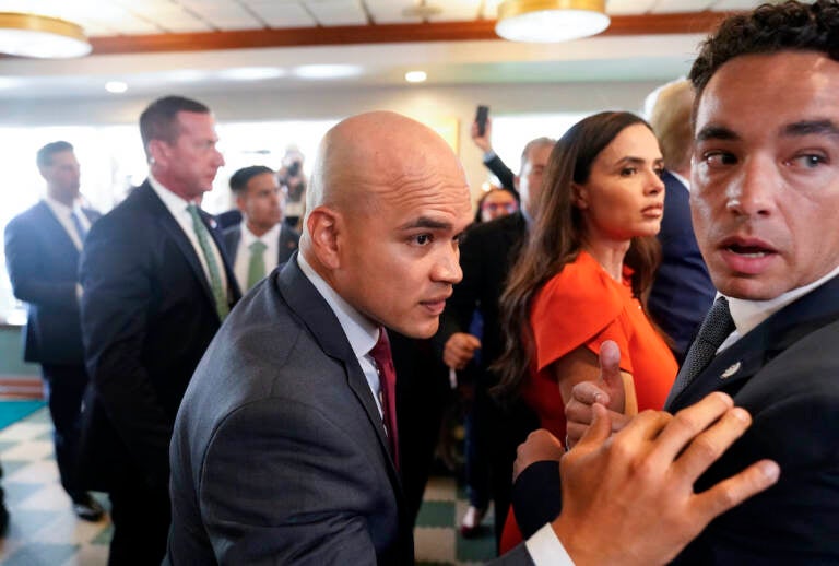 Former President Donald Trump's valet Walt Nauta, center, visits Versailles restaurant with Trump, June 13, 2023, in Miami. Nauta is set to be arraigned on charges that he helped the former president hide classified documents that the Justice Department wanted back. Nauta was charged earlier this month alongside Trump in a 38-count indictment filed by Justice Department special counsel Jack Smith.