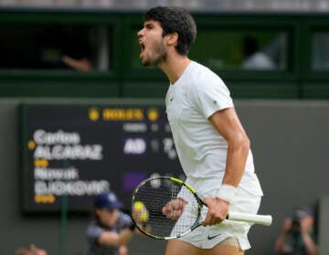 Spain's Carlos Alcaraz celebrates after winning a point against Serbia's Novak Djokovic in the final of the men's singles on day fourteen of the Wimbledon tennis championships in London