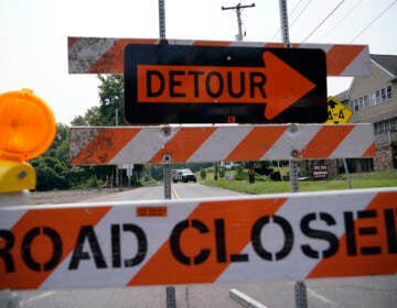 A roadblock is seen as crews search for a a pair of missing children swept away after weekend rains, Monday, July 17, 2023, in Washington Crossing, in Upper Makefield Township, Pa.