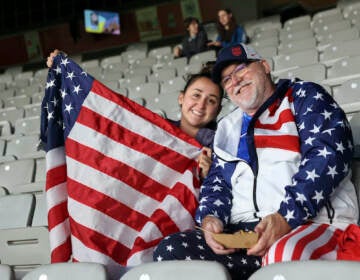 David Tritz, from Laguna Hills, California, and his daughter Erin Tritz, pose for a photo after taking their seats at the Women's World Cup soccer match between New Zealand and Norway in Auckland, New Zealand, Thursday, July 20, 2023. An estimated 20,000 Americans are coming to New Zealand for the Women's World Cup, and many have arrived in the days before the U.S. women's team plays its opener against Vietnam on Saturday