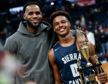 LeBron James (left) poses with his son Bronny after Sierra Canyon beat Akron St. Vincent - St. Mary in a high school basketball game, Saturday, Dec. 14, 2019, in Columbus, Ohio.