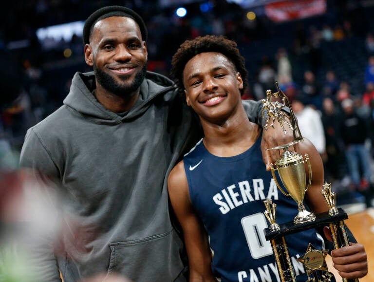 LeBron James (left) poses with his son Bronny after Sierra Canyon beat Akron St. Vincent - St. Mary in a high school basketball game, Saturday, Dec. 14, 2019, in Columbus, Ohio.