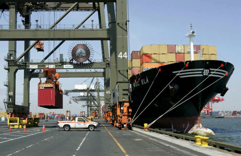 This Friday, April 21, 2006 file photo shows cargo containers stacked on the deck of a ship as a crane lifts another container at Port Newark in Newark, N.J.