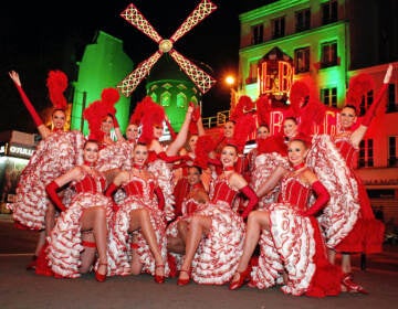 Dancers line up in front of the Moulin Rouge cabaret