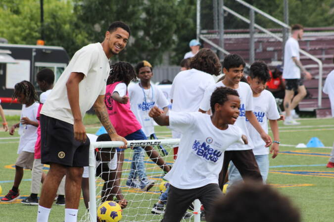 Chelsea defender Levi Colwell watches the kids practice their goal celebrations during drills