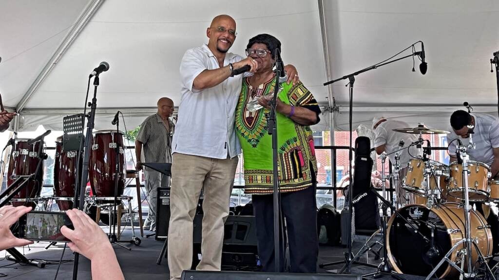 Pennsylvania State Sen. Vincent Hughes presents Callalily Coursar with the Outstanding Years of Service Award for her 35 years of work at the East Parkside Residents Association, during Lancaster Avenue Jazz and Arts Festival