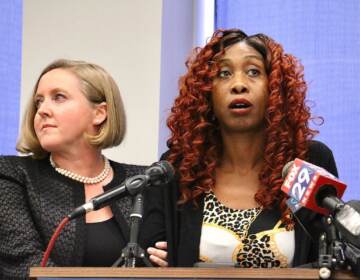 Angel Davis stands at a podium with her lawyer, Bethany Nikitenko