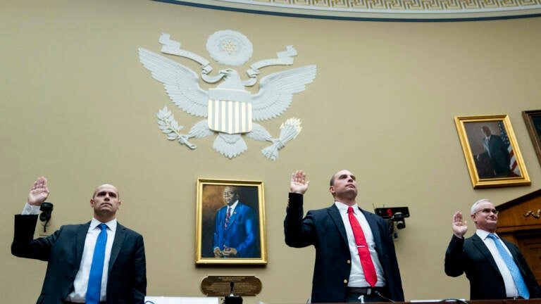 Ryan Graves, executive director of Americans for Safe Aerospace (left), retired Air Force Maj. David Grusch and retired Navy Cmdr. David Fravor are sworn in during a House Oversight and Accountability subcommittee hearing on UFOs on Wednesday.