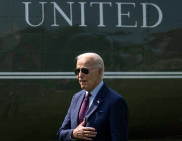 President Biden places his hand over his heart.