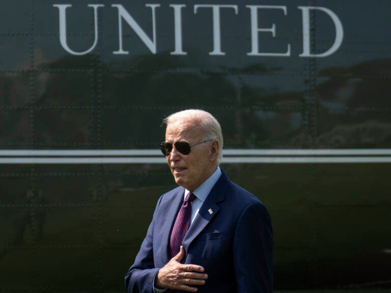 President Biden places his hand over his heart.