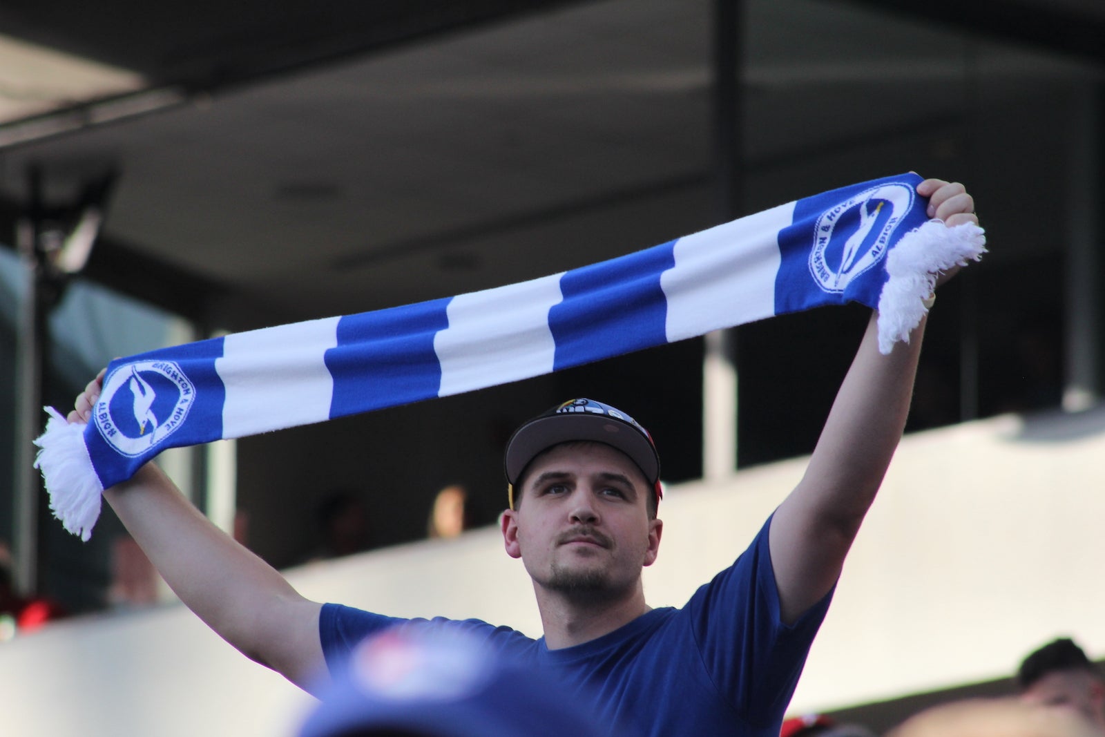 A Chelsea FC fan holds up a scarf in support of the team at Lincoln Financial Field