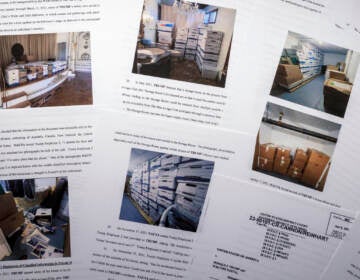 Documents with photos shown on the pages of former President Trump's indictment