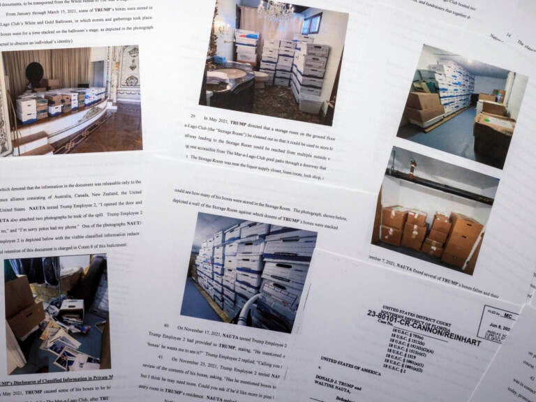 Documents with photos shown on the pages of former President Trump's indictment