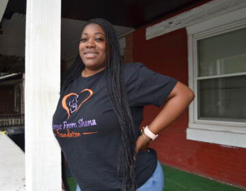 Cleopatra Herrera standing on a front porch.