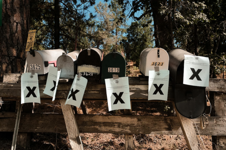 A row of mailboxes tagged with evacuation notices during the Oak Fire in Mariposa, Calif.