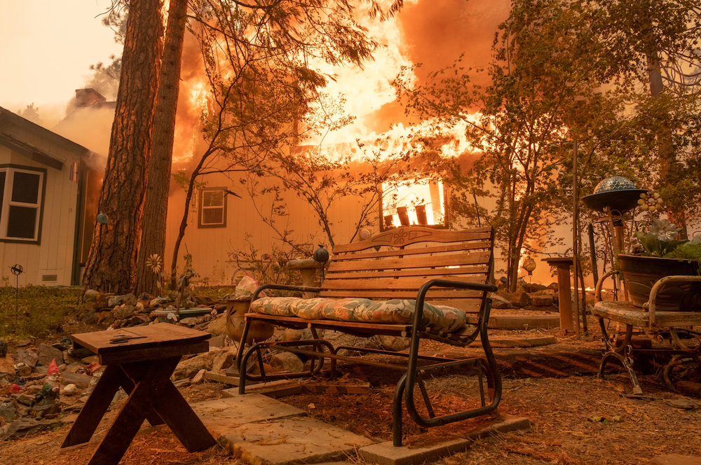 A structure burns during the Oak Fire in Mariposa Count