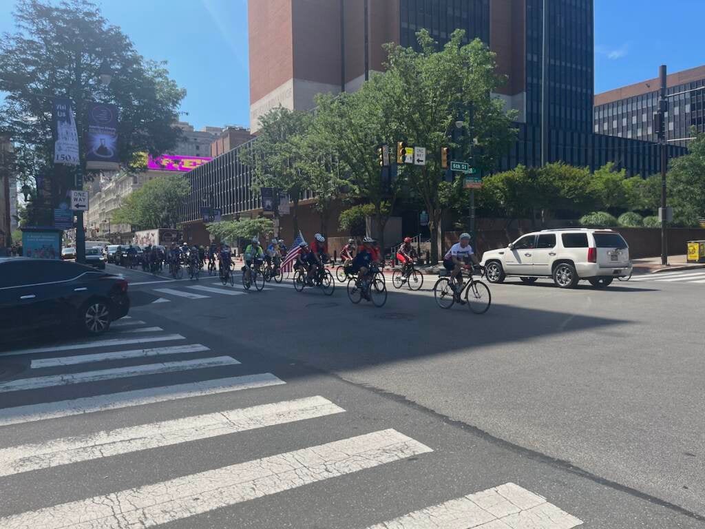 Cyclists stream down Market Street. 