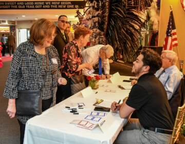 Checking in to the 50th anniversary party for Dignity Philadelphia, held May 2023 at the Mummers Museum