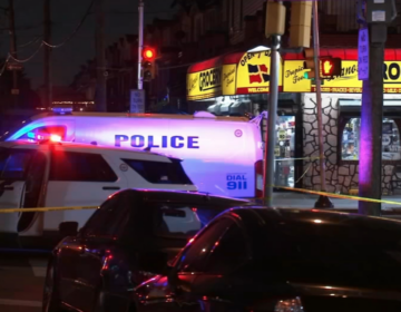 Police comb the scene of a mass shooting at D Street and Wyoming Avenue in Philadelphia.