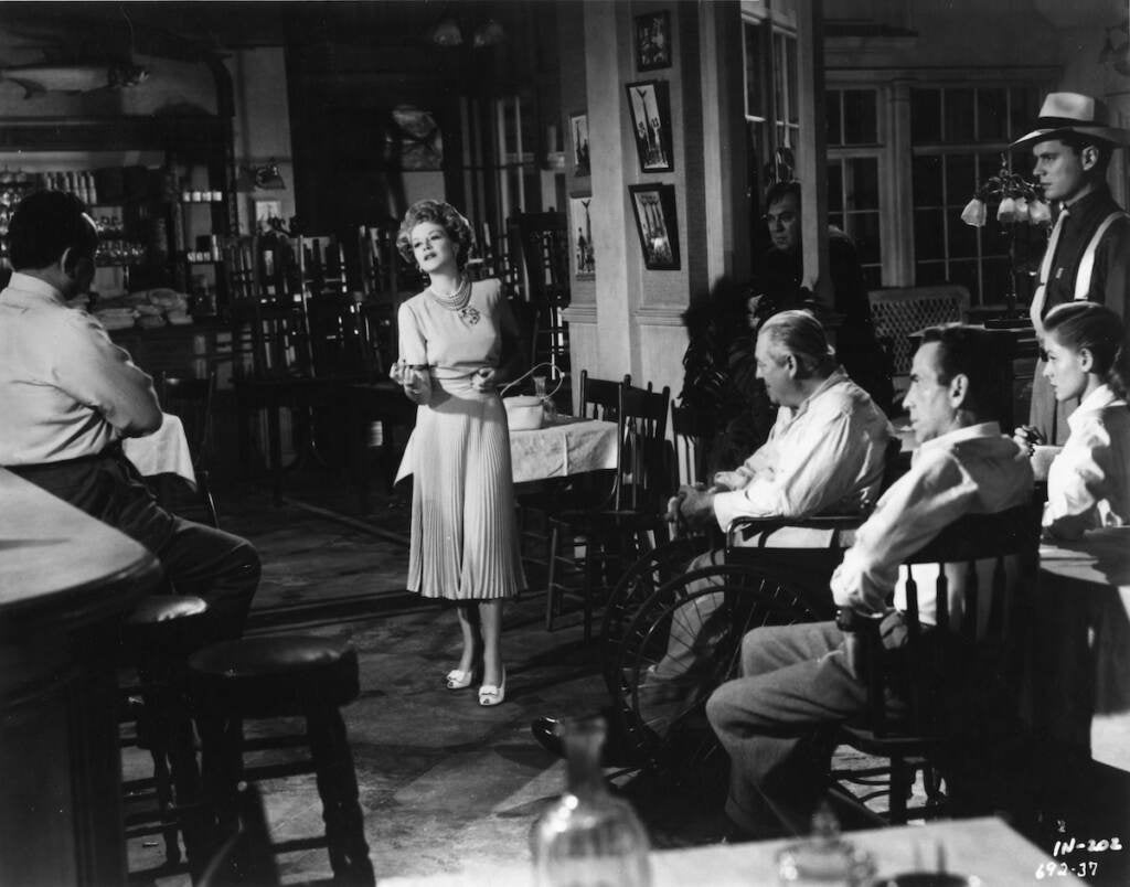 Claire Trevor singing “Moanin’ Low” in a black-and-white film still from the movie "Key Largo."